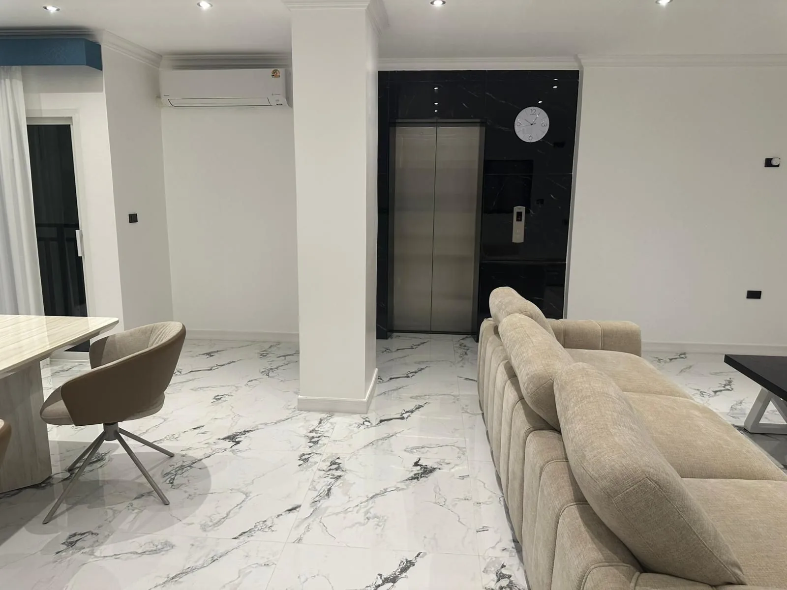 Private elevator, black marble wall, clock